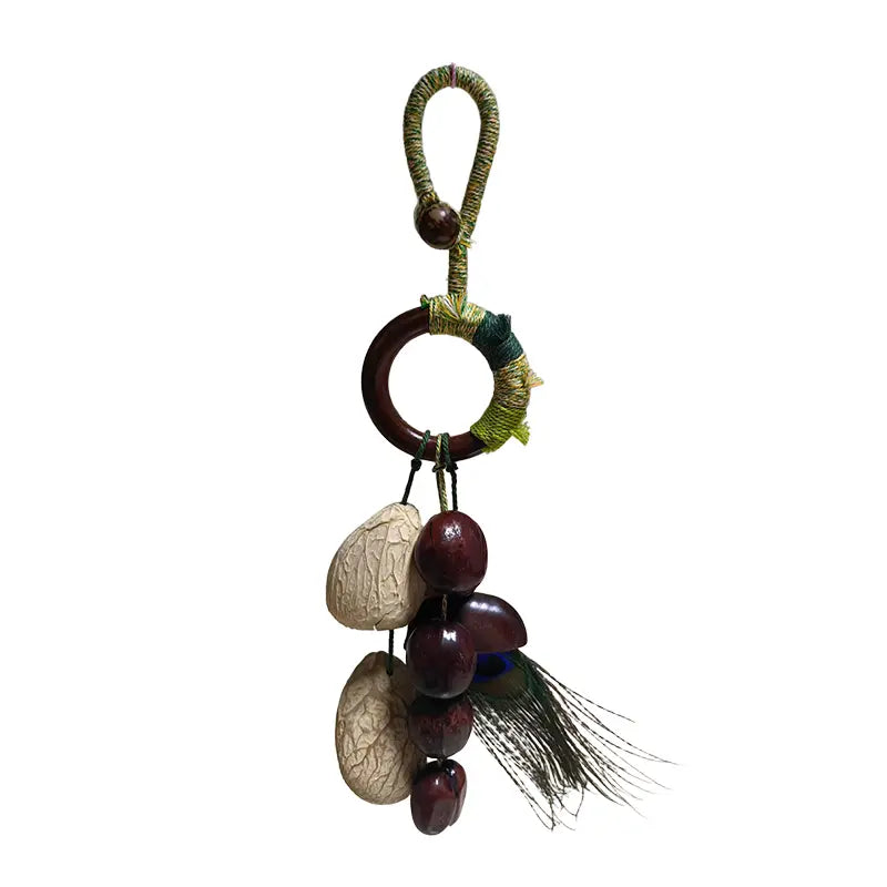 Handmade fruit shell bell bag strap with peacock feather