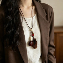 Twin Pods natural seed necklace — two hanging pods — glossy red-brown seed and dark wood piece, handmade boho pendant on adjustable cord