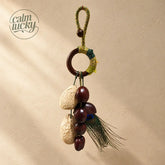 Handmade fruit shell bell bag strap with peacock feather