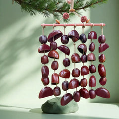 Plum Dusk fruit shell wind chime with deep purple-red seed pods