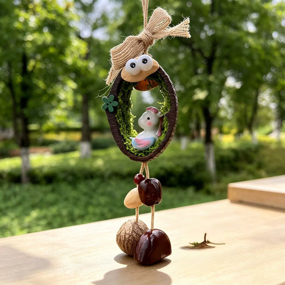 Horse zodiac chime — little white horse with pink and blue mane in a mossy nut shell nest with googly eyes and seed bells