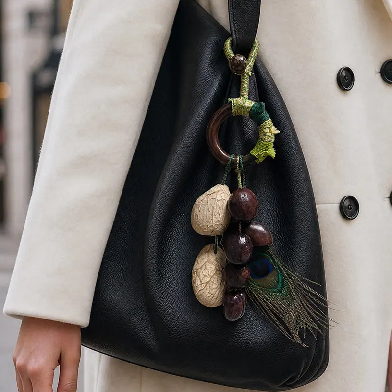 Artisan wooden ring bag charm with seed beads and peacock feather, winter coat styling