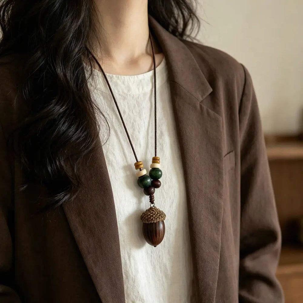 Forest Acorn natural seed necklace — carved wooden acorn under dark green jade beads, handmade boho pendant on adjustable cord
