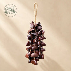 Handmade dark brown textured seed wind chime hanging, handheld natural chime