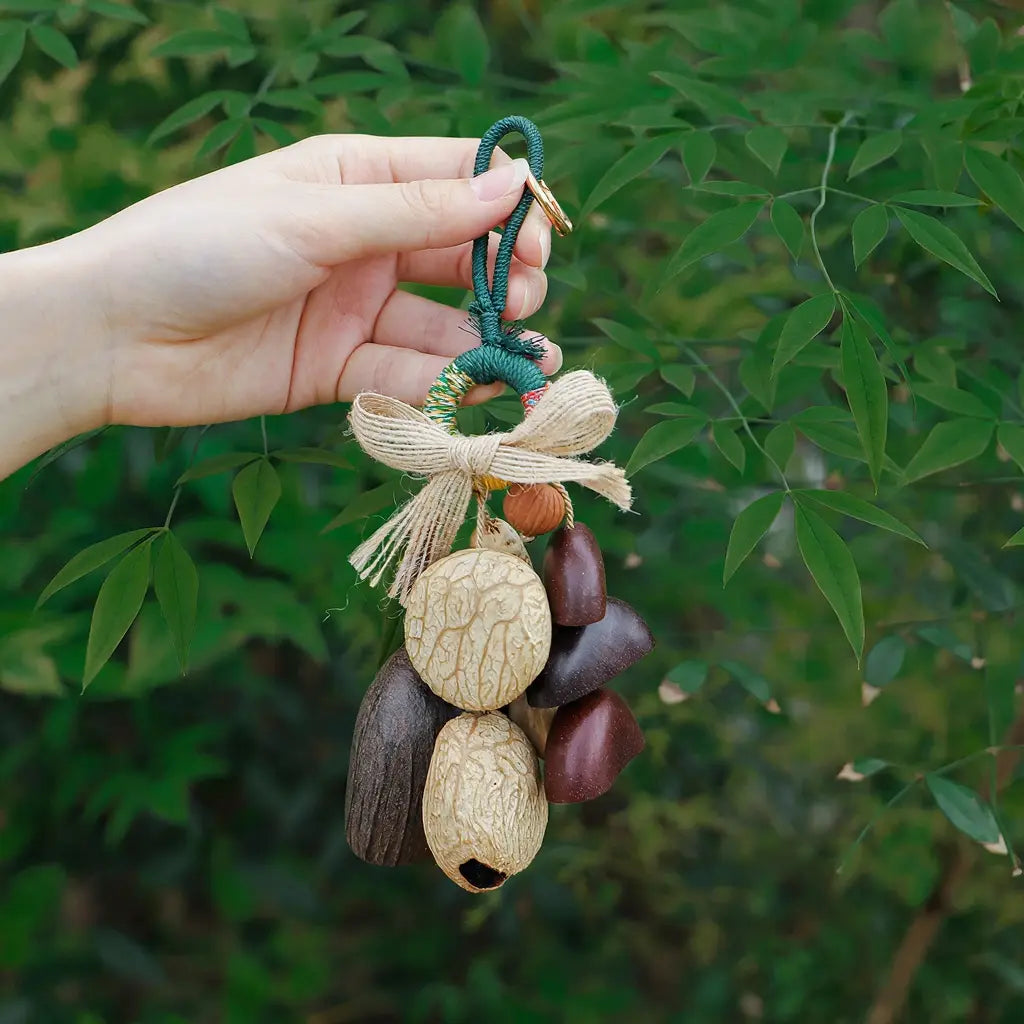 Forest Cap seed charm — carved natural shell cap bell bag charm