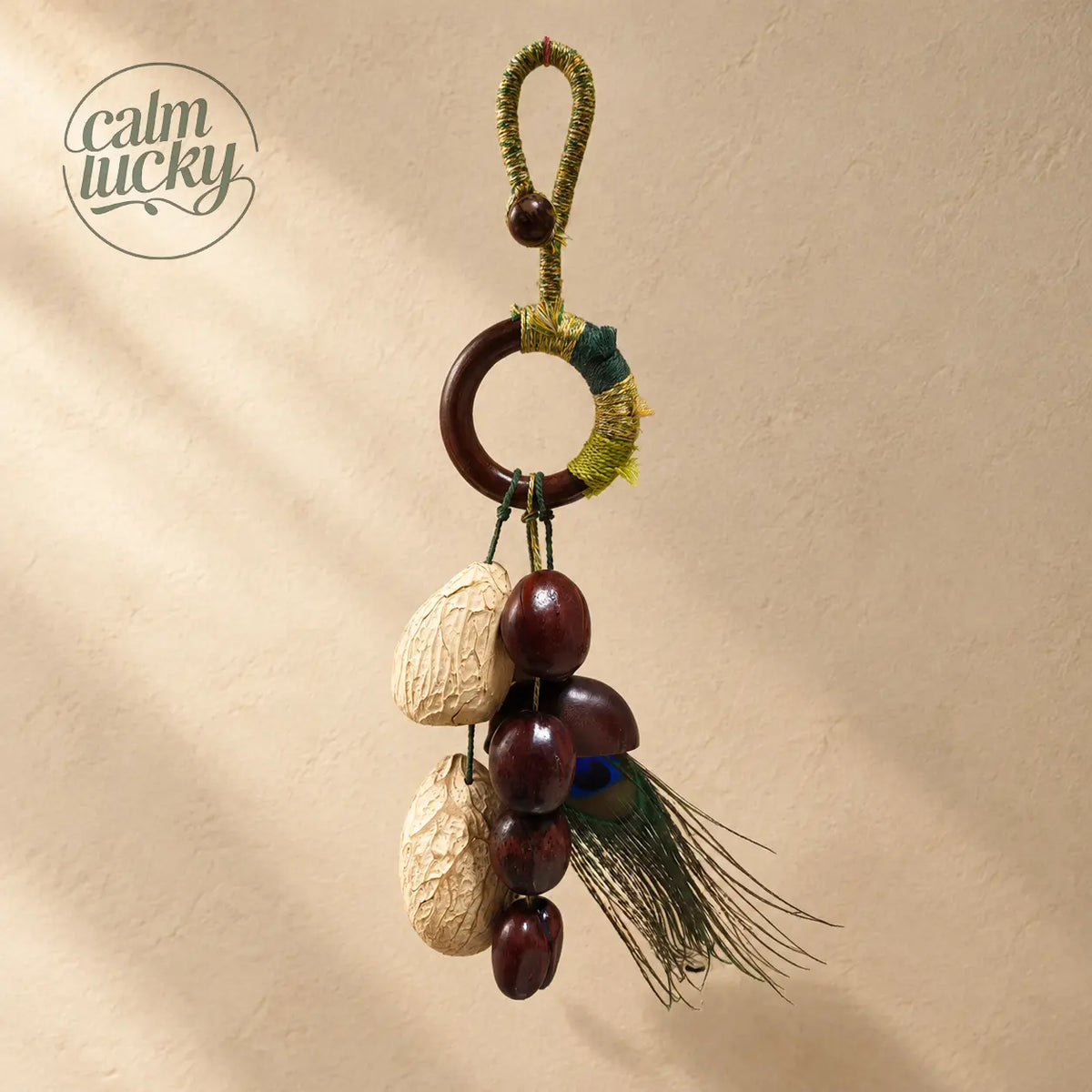 Handmade fruit shell bell bag strap with peacock feather