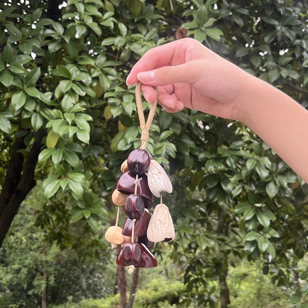 Handmade Burgundy Bells bag charm with deep wine-red bell-shaped shells and cream accents on cotton cord, elegant vintage keychain