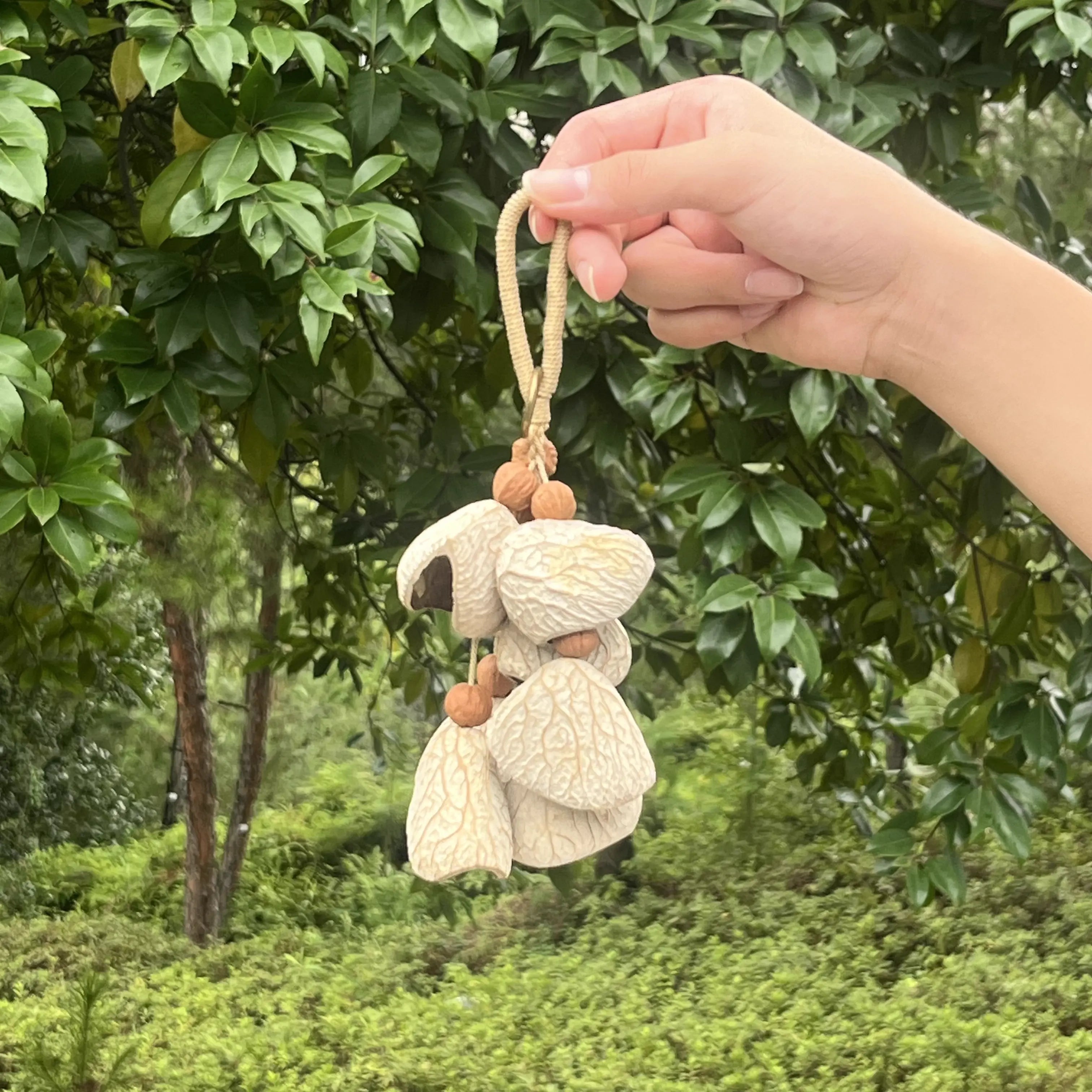 Handmade Pure Cotton bag charm with white cracked seed shells on soft cotton cord, minimal zen natural keychain
