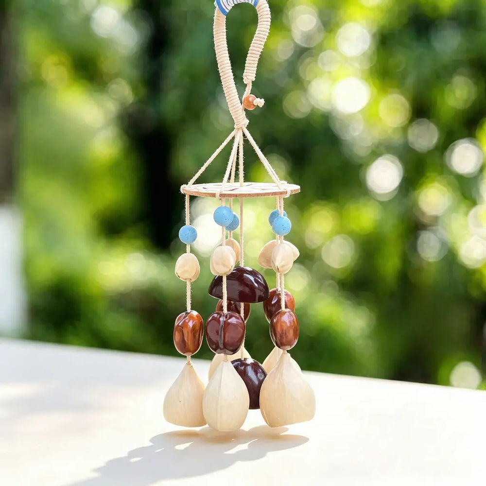 Natural wind chime with carved wooden spacer beads, white round beads and mixed dark and ivory seed pods