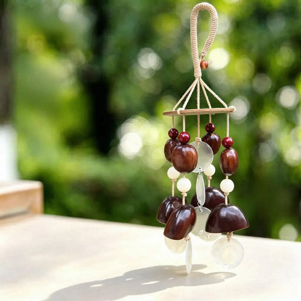 Handmade wind chime with amber-orange seed beads, white jade beads and translucent shell pieces on natural cord