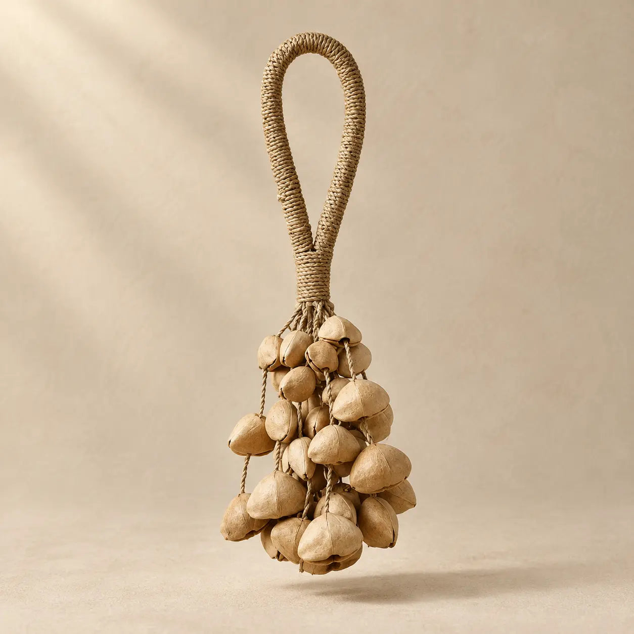 Handmade Chacha seed pod rattle with 42 natural beige pods (14 per strand, three clusters) on a wrapped fiber loop handle, soft shaker sound for meditation