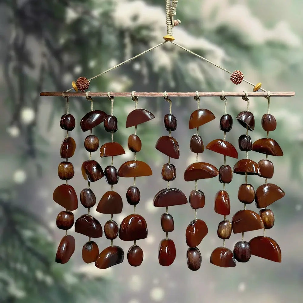 Cardamom Night fruit shell wind chime with polished dark bean pods