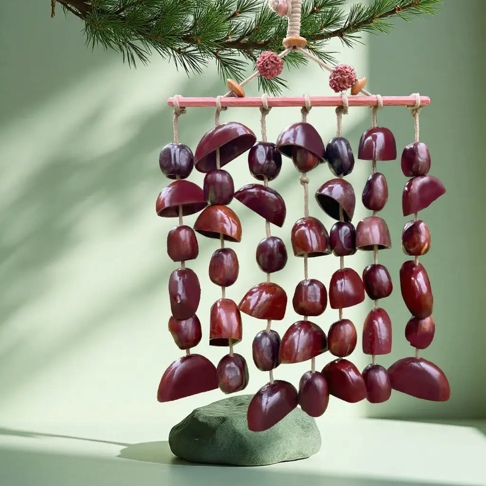 Plum Dusk fruit shell wind chime with deep purple-red seed pods