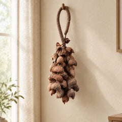 Handmade moonin crescent entada seed chime hanging by a sunlit sheer-curtained window