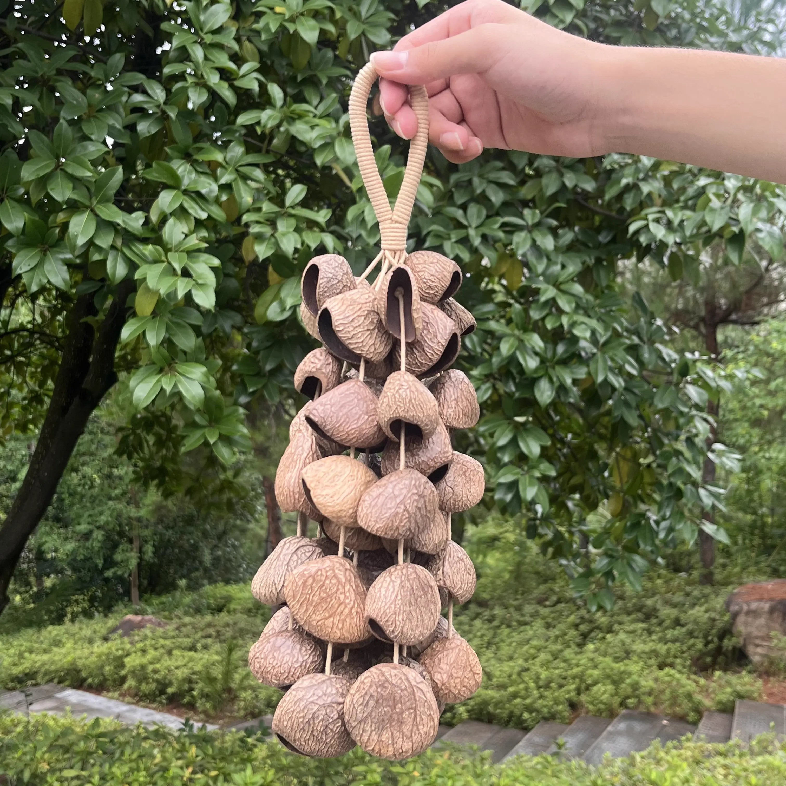 Large Panji 72-seed wind chime hanging on a garden porch, a full-sounding handmade natural centerpiece