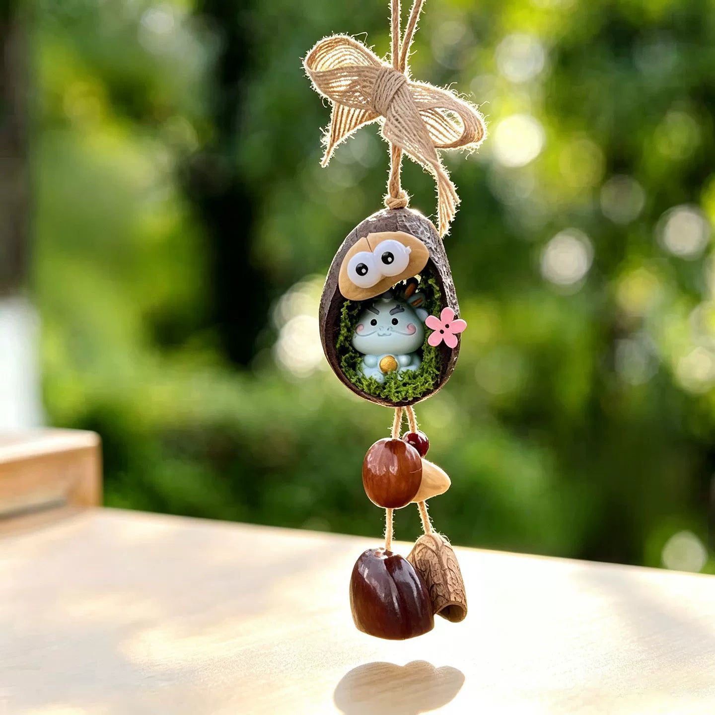 Dragon zodiac chime — light blue dragon holding a pearl in a mossy nut shell nest with googly eyes and seed bells