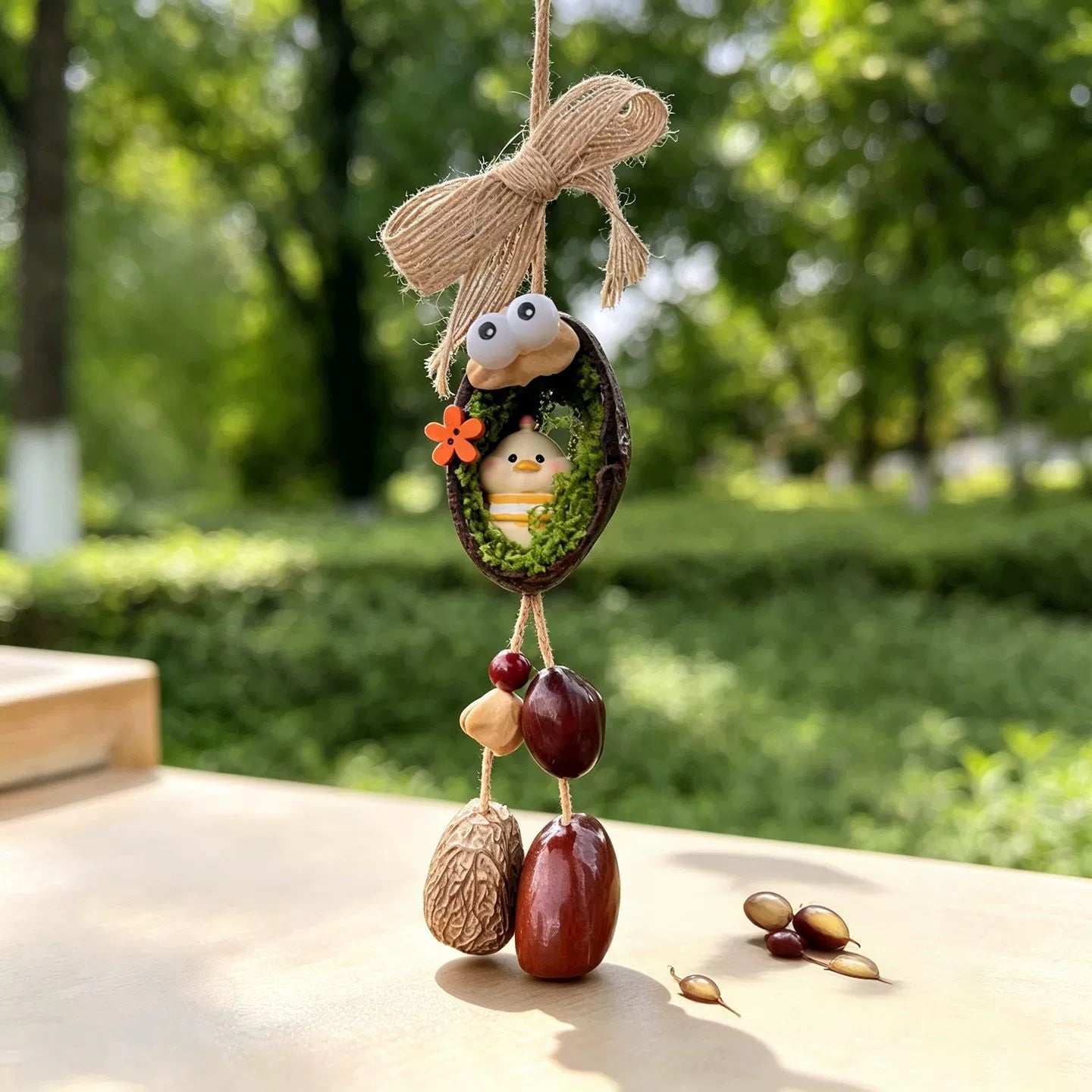 Rooster zodiac chime — little yellow chick with red crest in a mossy nut shell nest with googly eyes and seed bells